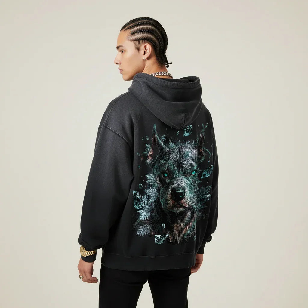 Person wearing a black hoodie with a Pitbull graphic on the back against a plain background