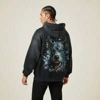 Person wearing a black hoodie with a Pitbull graphic on the back against a plain background