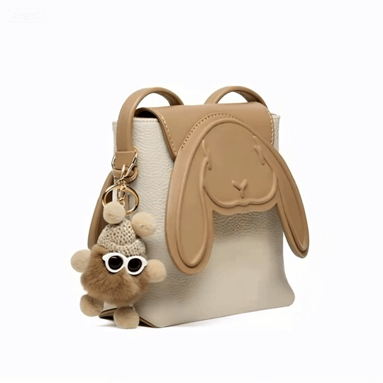 Beige purse with bunny face flap and cute fuzzy keychain accessory