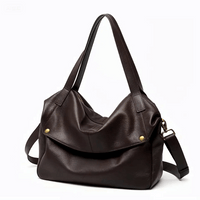 Dark brown leather shoulder bag with gold-tone studs and detachable strap on white background