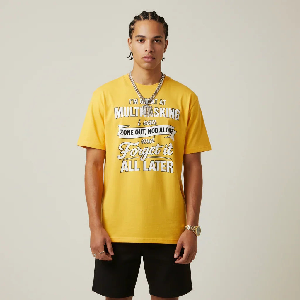 Person wearing a I'm Great at Multitasking yellow t-shirt on a plain background