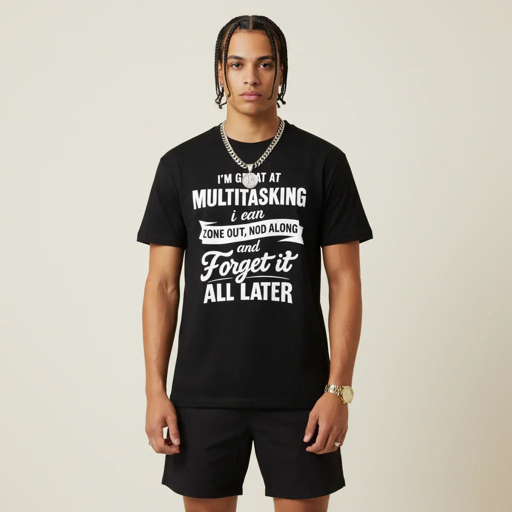 Person wearing a I'm Great at Multitasking black t-shirt on a plain background