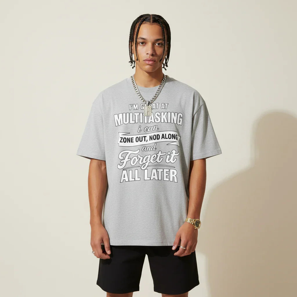 Person wearing a I'm Great at Multitasking grey t-shirt on a plain background