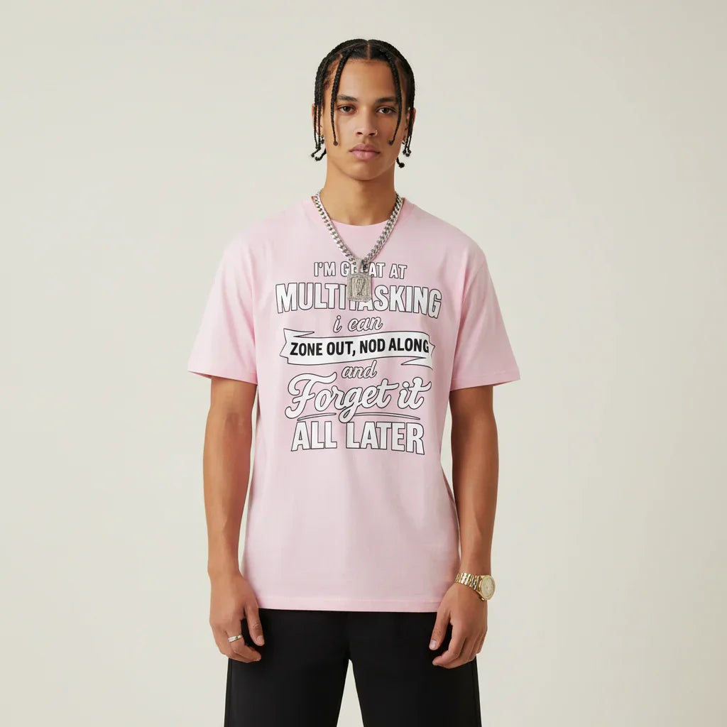 Person wearing a I'm Great at Multitasking pink t-shirt on a plain background