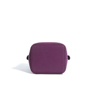 Purple leather crossbody bag with square shape on white background