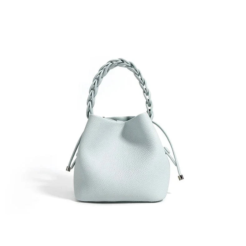 Light blue leather handbag with braided handle and drawstring, minimalist style