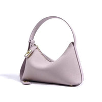 Light purple leather shoulder bag with gold hardware on white background