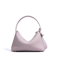 Pastel purple leather handbag with top handle and gold hardware on white background