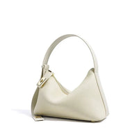 Cream leather hobo bag with gold zipper and minimalist design on white background