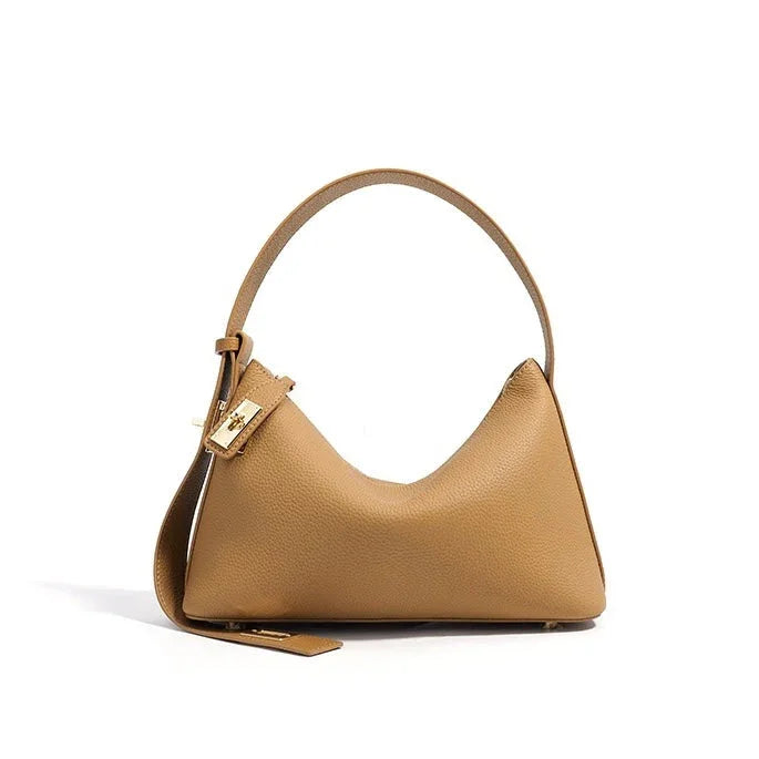Tan leather shoulder bag with gold buckle on white background