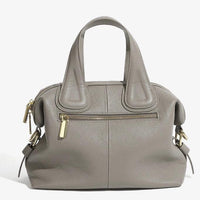 Taupe leather handbag with gold zippers and top handles on white background