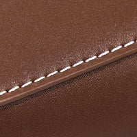 Closeup of brown leather with white stitching detail