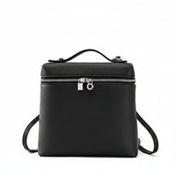 Black leather backpack with top handle, silver zipper, and lock on white background