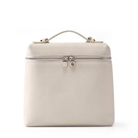 Beige leather handbag with top handle and silver zipper on white background