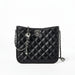 Black quilted leather crossbody bag with silver chain strap and metal logo on white background