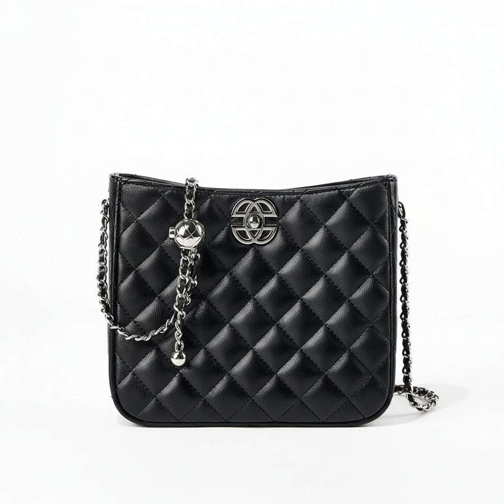 Black quilted leather crossbody bag with silver chain strap and metal logo on white background