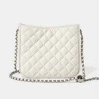 White quilted crossbody bag with silver chain strap on plain background