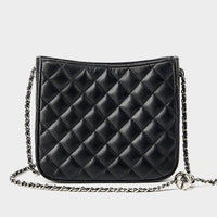 Black quilted leather crossbody bag with silver chain strap on white background