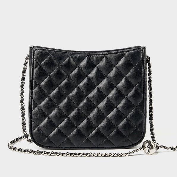 Black quilted leather crossbody bag with silver chain strap on white background