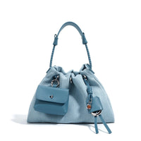 Blue denim drawstring handbag with braided handle and attached pocket