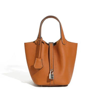 Brown leather tote bag with top handle and silver lock on white background