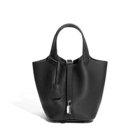 Black textured leather tote bag with top handles and silver lock against white background