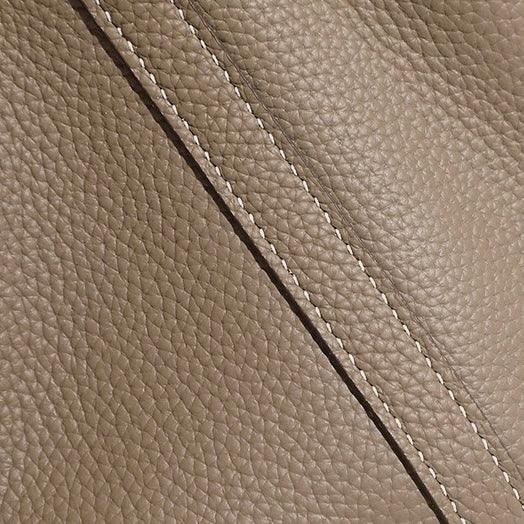 Textured taupe leather with diagonal stitching, close-up luxury material detail