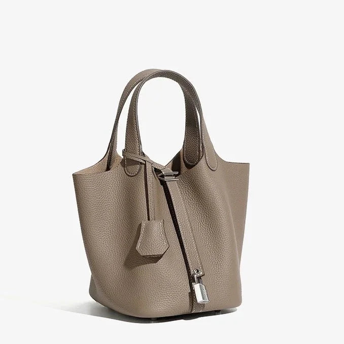 Taupe leather tote bag with textured finish, double handles, and silver padlock detail