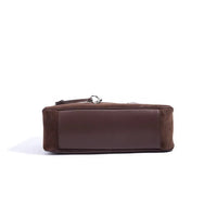 Bottom view of brown suede and leather rectangular bag on white background