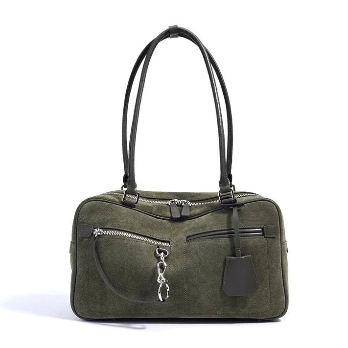 Olive green suede handbag with black leather handles and silver zippers
