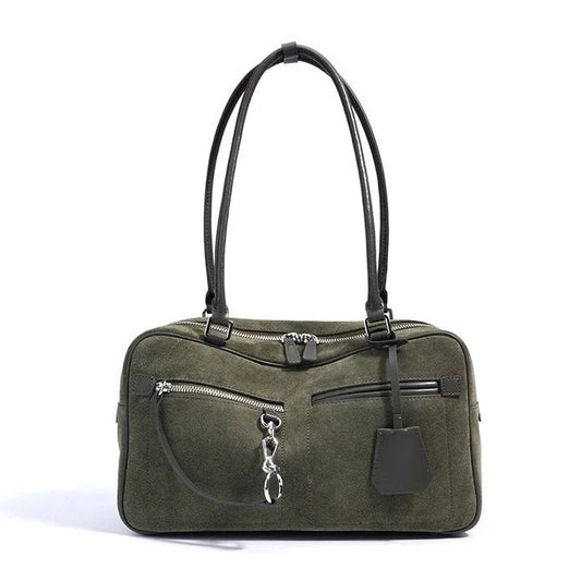 Olive green suede handbag with black leather handles and silver zippers