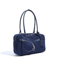 Navy blue suede handbag with double handles and zippered front pocket on white background
