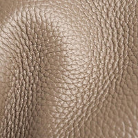 Close up of taupe pebbled leather texture, grain pattern, luxury handbag material