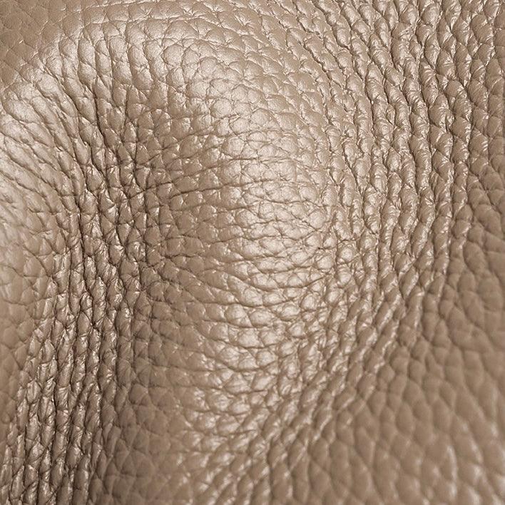 Close up of taupe pebbled leather texture, grain pattern, luxury handbag material