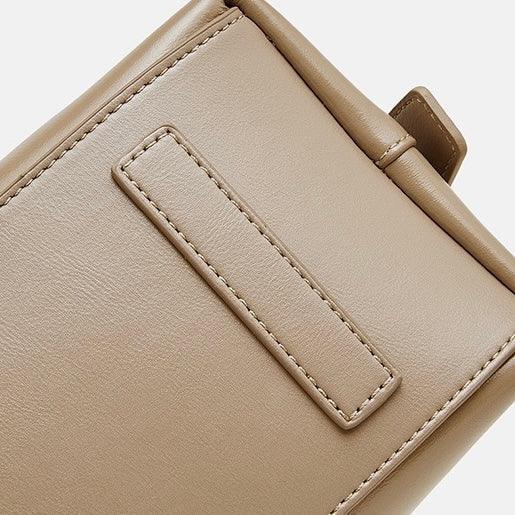 Beige vegan leather bag close-up with fine stitching and strap detail