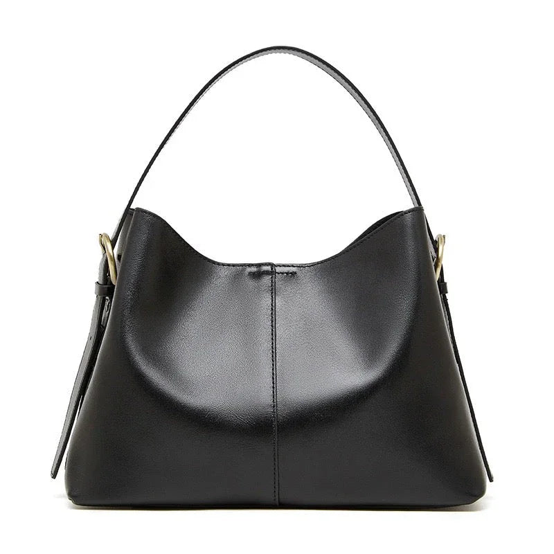 Black leather hobo handbag with gold hardware on white background