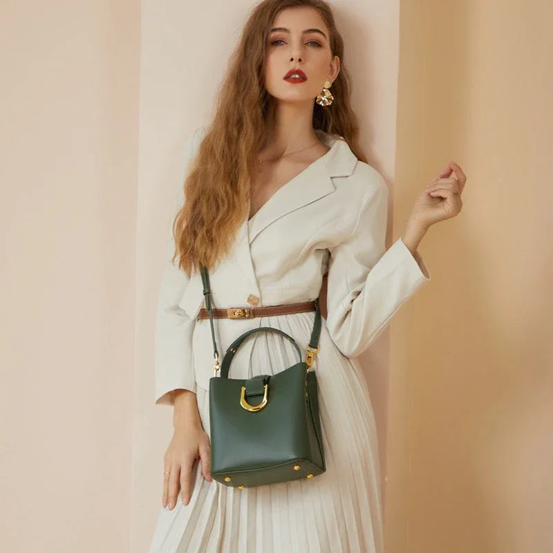 Woman in white dress with brown belt and green leather handbag, fashion photoshoot
