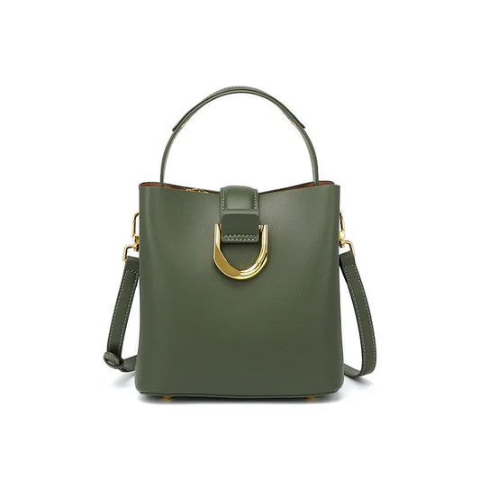 Olive green leather handbag with gold buckle, top handle, and detachable strap on white background