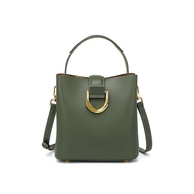 Olive green leather handbag with gold buckle, top handle, and detachable strap on white background