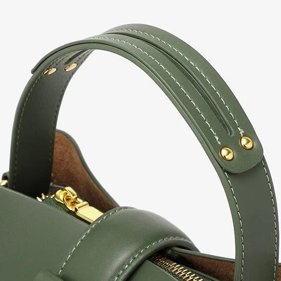 Green leather handbag with gold hardware and adjustable top handle
