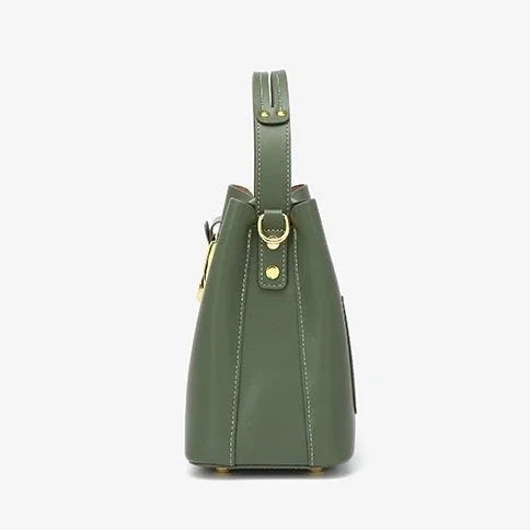 Side view of olive green leather handbag with gold hardware on a white background