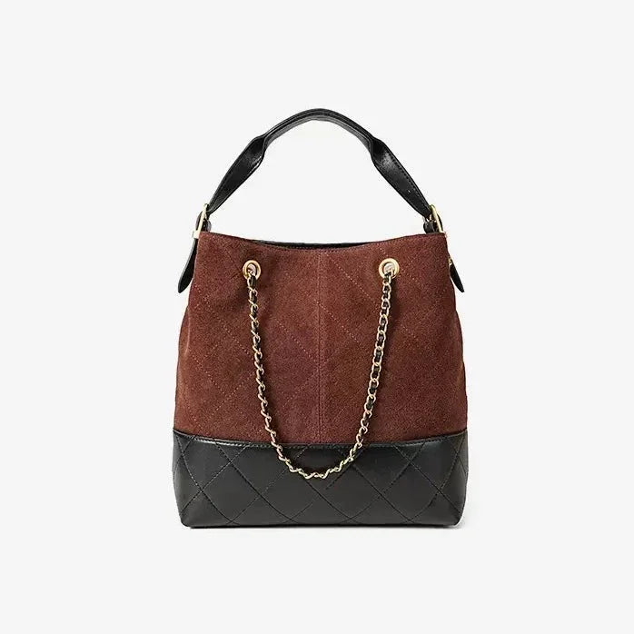 Two-tone brown and black suede bucket bag with gold chain strap and quilted leather base