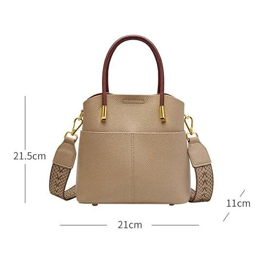 Beige leather handbag with brown handles, gold hardware, braided strap, and size dimensions