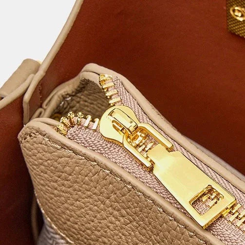 Beige leather handbag interior with gold zipper detail