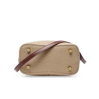 Beige leather crossbody bag with gold feet and brown strap on white background