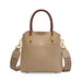Taupe leather handbag with brown handles, gold hardware, and woven shoulder strap