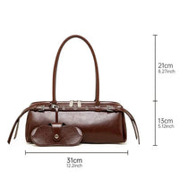 Brown leather handbag with long handles, matching pouch, and size dimensions shown