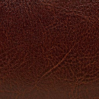 Close-up of brown genuine leather texture with natural grain and creases