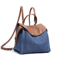 Blue denim backpack with brown leather flap and adjustable shoulder straps