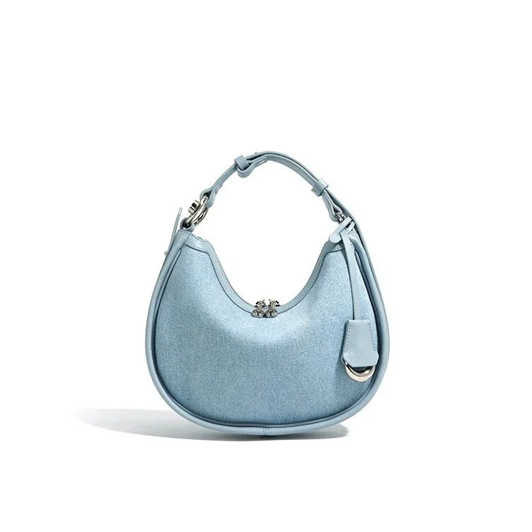 Light blue crescent shoulder bag with silver hardware and decorative flower clasp